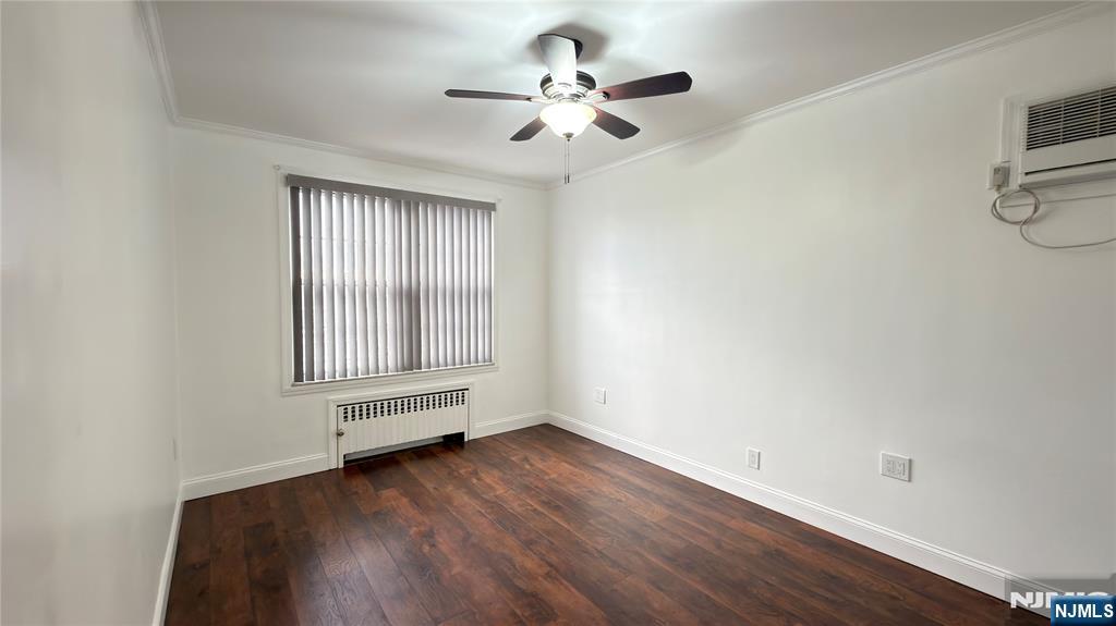 376 Delano Place, Unit 2 Fairview, NJ 07022 - Photo 19 of 21 an empty room with wooden floor chandelier fan and windows