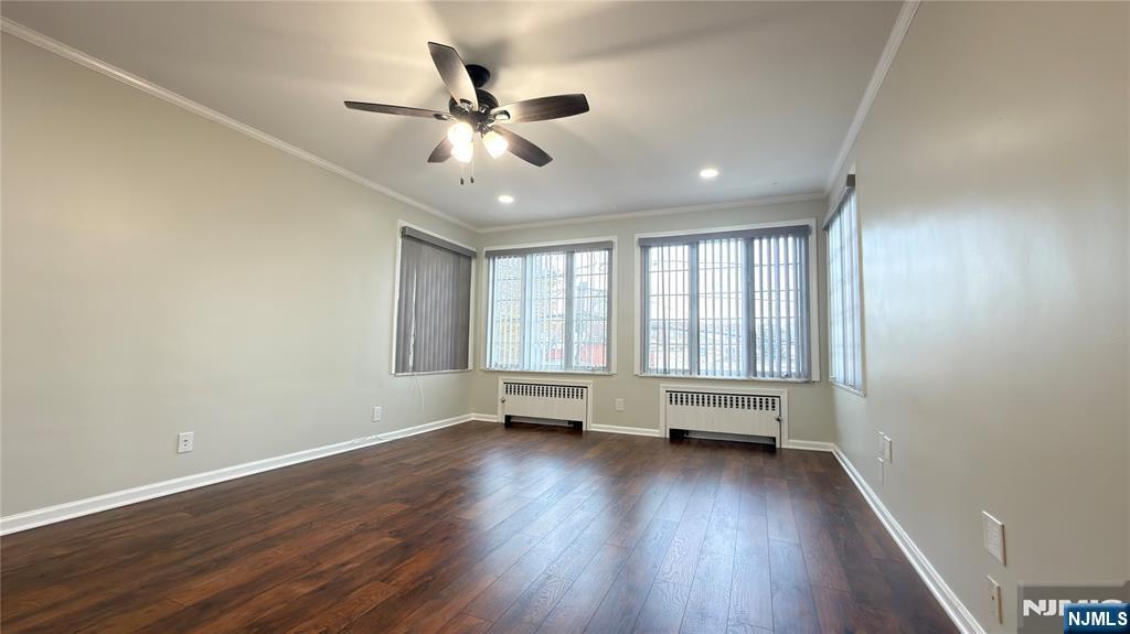 376 Delano Place, Unit 2 Fairview, NJ 07022 - Photo 3 of 21 an empty room with wooden floor and windows