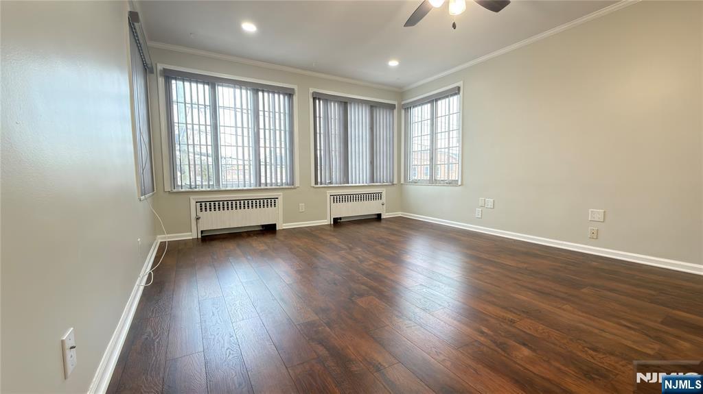 376 Delano Place, Unit 2 Fairview, NJ 07022 - Photo 4 of 21 an empty room with wooden floor and windows