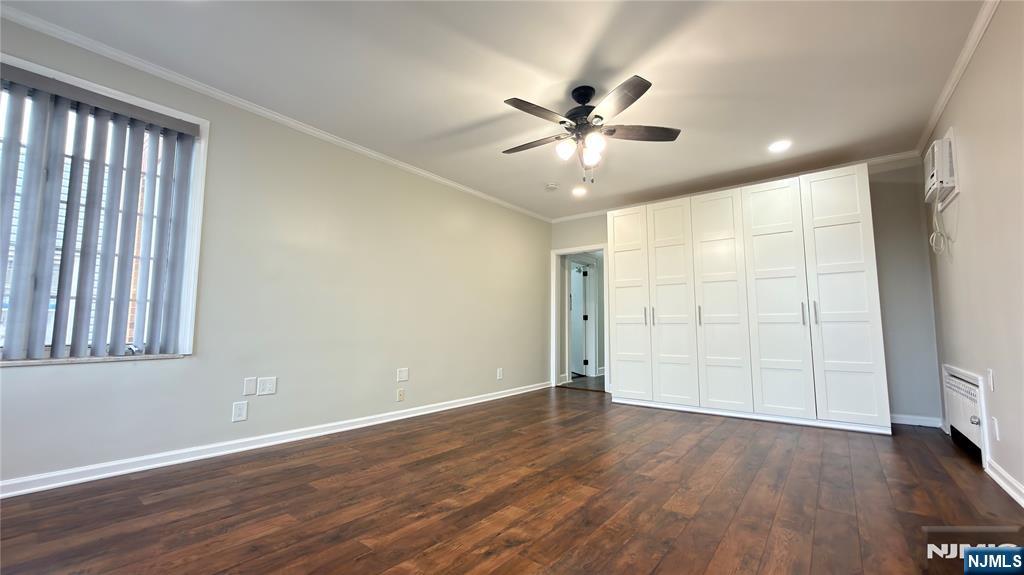 376 Delano Place, Unit 2 Fairview, NJ 07022 - Photo 5 of 21 a view of an empty room with wooden floor and a window