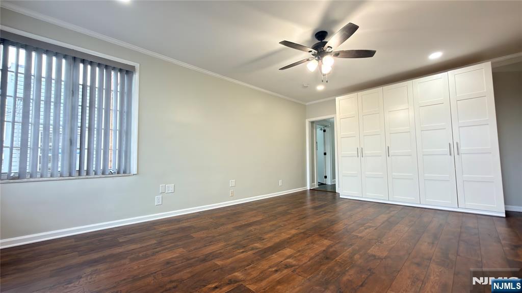 376 Delano Place, Unit 2 Fairview, NJ 07022 - Photo 6 of 21 an empty room with wooden floor and windows