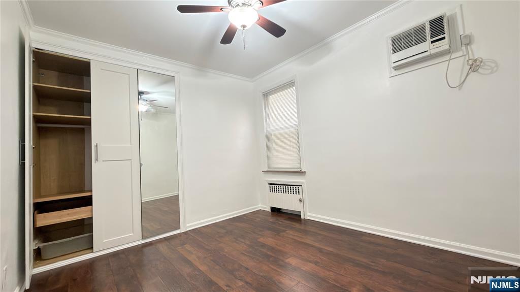 376 Delano Place, Unit 2 Fairview, NJ 07022 - Photo 7 of 21 an empty room with wooden floor closet and windows
