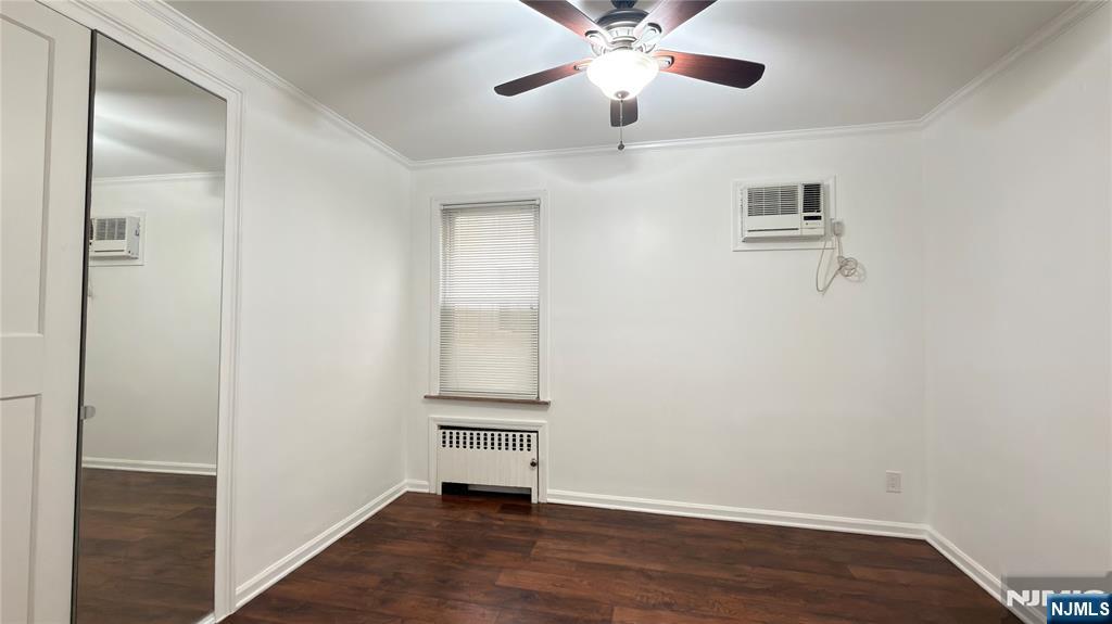 376 Delano Place, Unit 2 Fairview, NJ 07022 - Photo 8 of 21 an empty room with wooden floor fan and windows