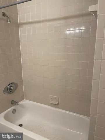 a bathroom with a bathtub and shower