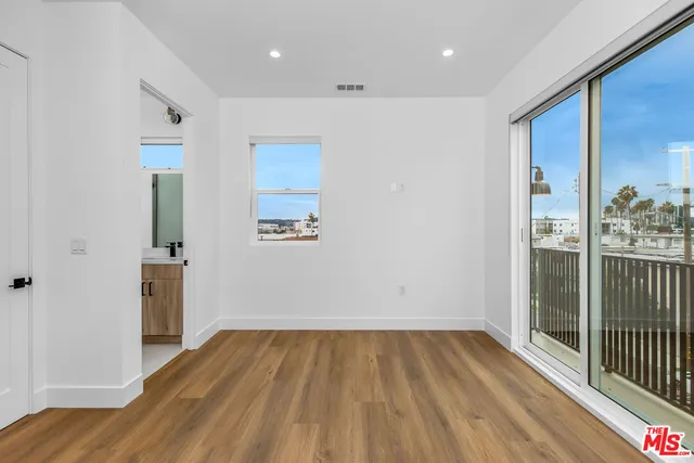 a view of a room with wooden floor stairs and a bathroom
