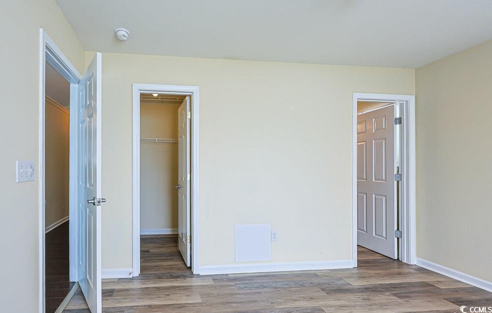 833 Silvercrest Drive Myrtle Beach, SC 29579 - Photo 13 of 30 Unfurnished bedroom with a spacious closet and wood finished floors