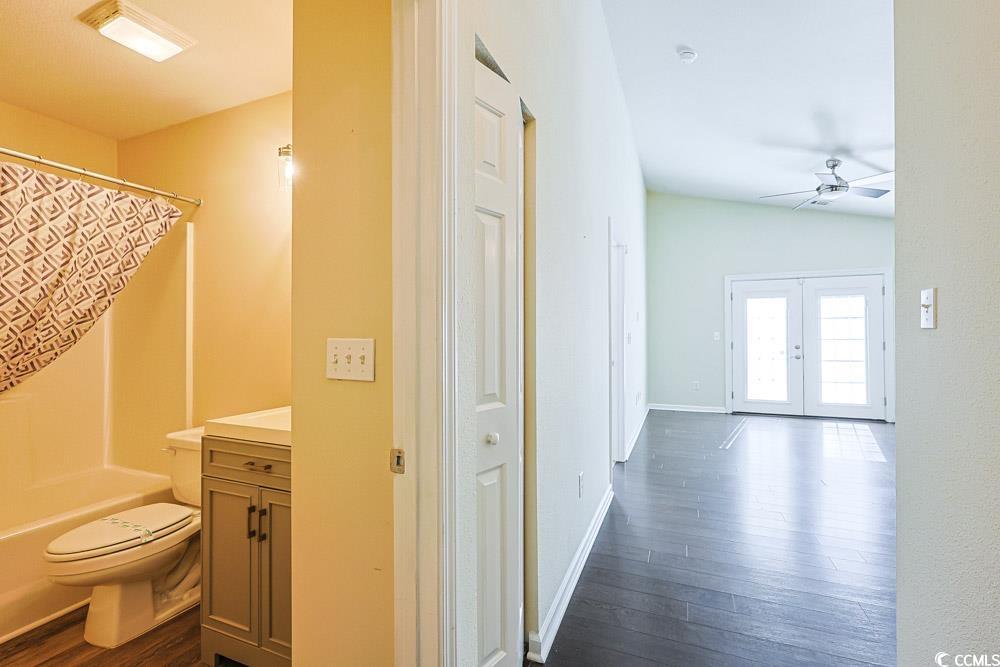 833 Silvercrest Drive Myrtle Beach, SC 29579 - Photo 19 of 30 Bathroom with vanity, dark wood finished floors, shower / bath combo, ceiling fan, and french doors