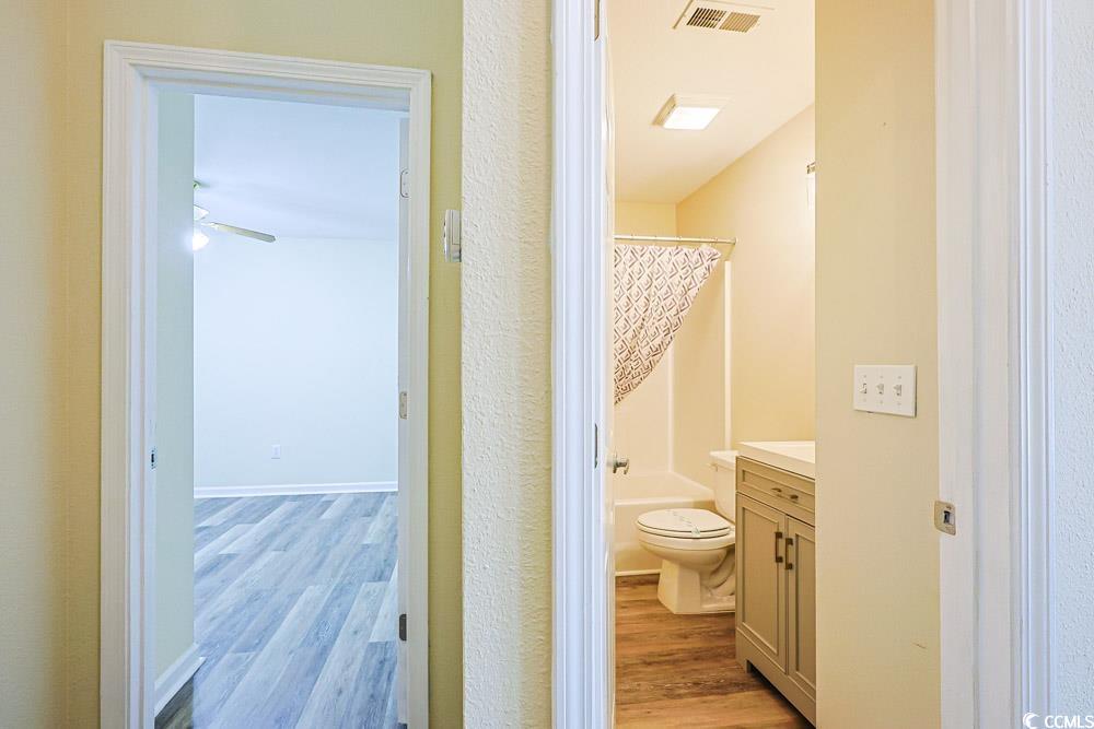 833 Silvercrest Drive Myrtle Beach, SC 29579 - Photo 20 of 30 Full bathroom featuring vanity, light wood-type flooring, and shower / tub combo with curtain