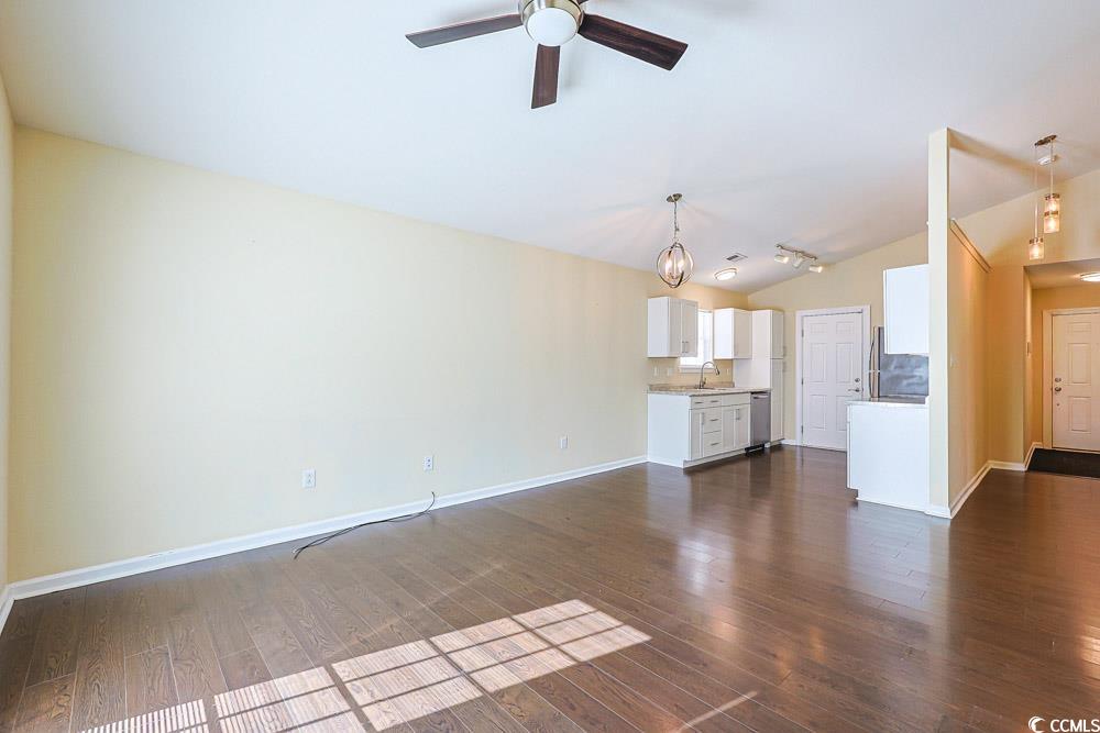 833 Silvercrest Drive Myrtle Beach, SC 29579 - Photo 5 of 30 Unfurnished living room featuring vaulted ceiling, dark wood finished floors, and ceiling fan