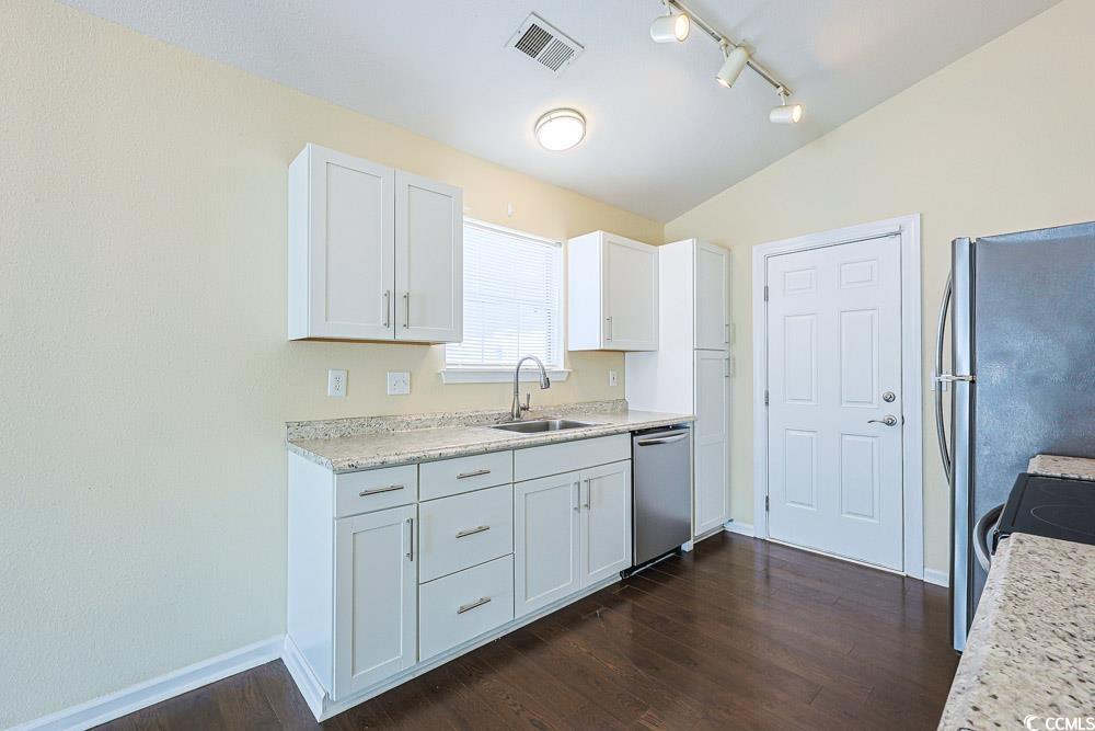 833 Silvercrest Drive Myrtle Beach, SC 29579 - Photo 7 of 30 Kitchen with white cabinetry, dark wood-style floors, stainless steel dishwasher, lofted ceiling, and black range with electric stovetop