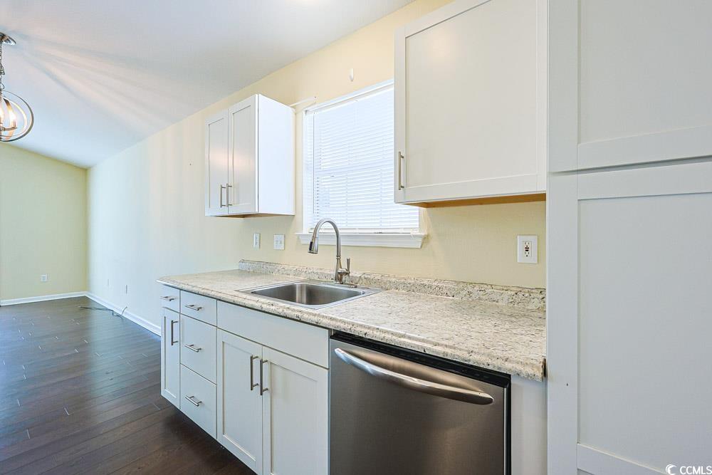 833 Silvercrest Drive Myrtle Beach, SC 29579 - Photo 9 of 30 Kitchen with dishwasher, light countertops, white cabinets, dark wood-type flooring, and a chandelier