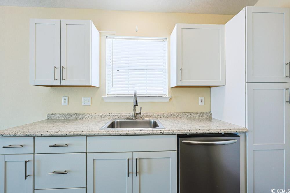 833 Silvercrest Drive Myrtle Beach, SC 29579 - Photo 10 of 30 Kitchen featuring dishwasher, white cabinets, and light stone counters
