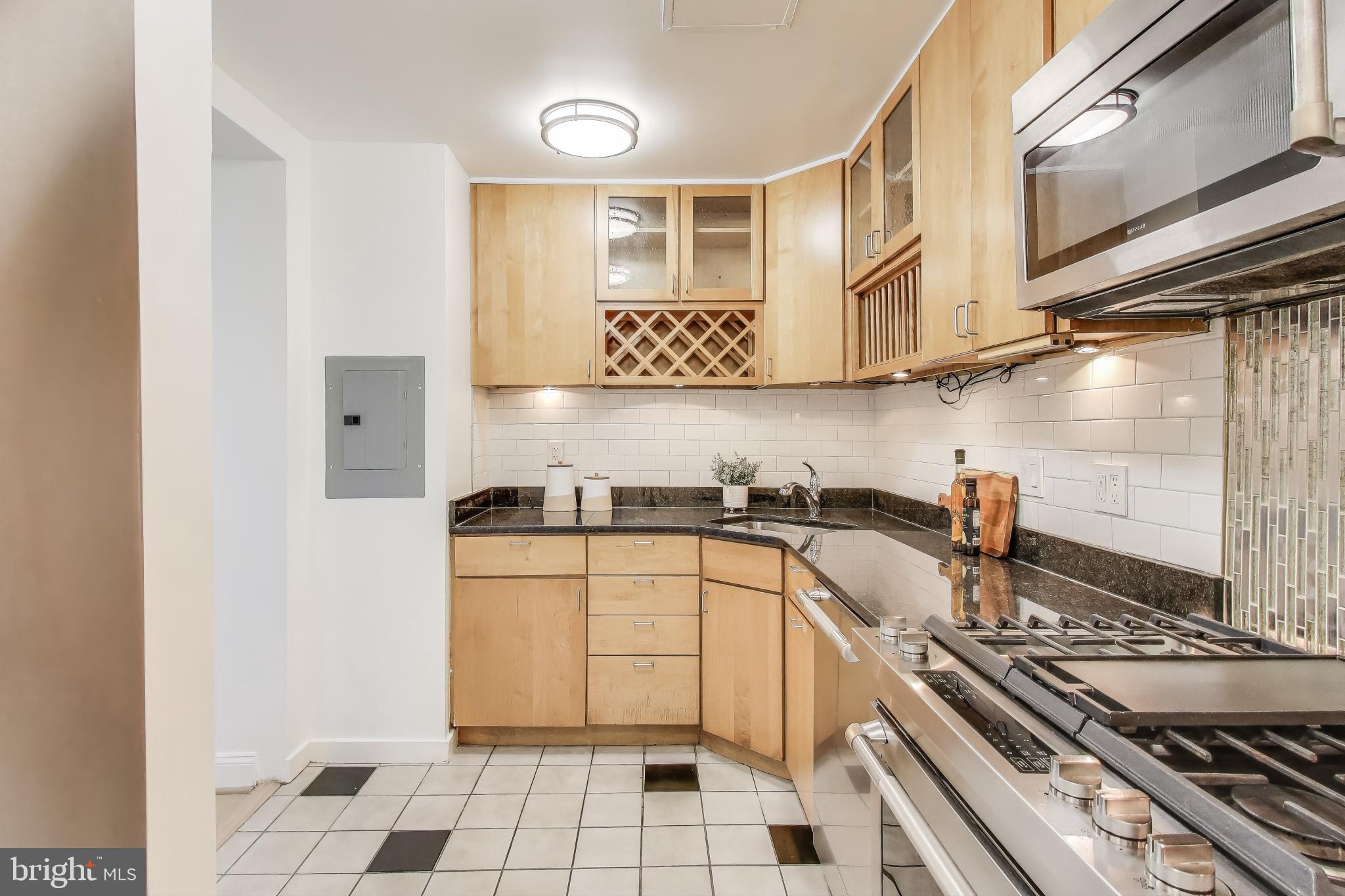 490 M Street Southwest, Unit W802 Washington, DC 20024 - Photo 11 of 23 a kitchen with a stove a sink and a refrigerator