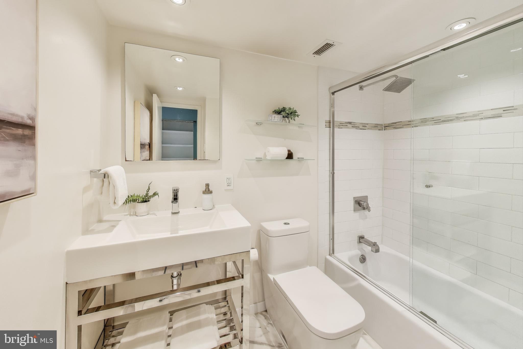 490 M Street Southwest, Unit W802 Washington, DC 20024 - Photo 14 of 23 a bathroom with a sink toilet and shower