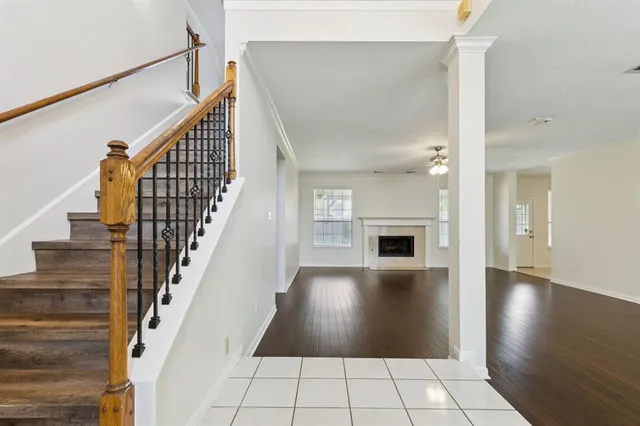a view of an entryway and livingroom with wooden floor