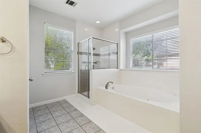 a spacious bathroom with a bathtub and a shower