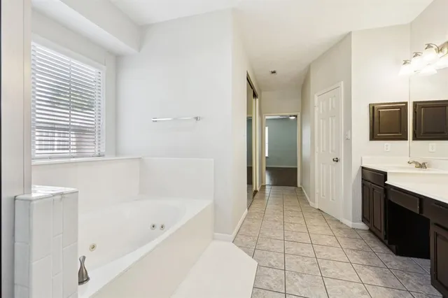 a bathroom with a bathtub and a sink