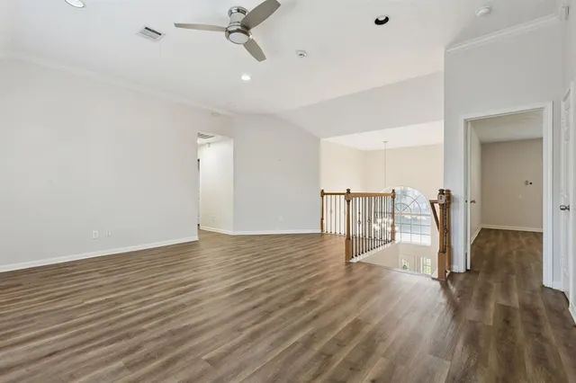a view of a room with wooden floor