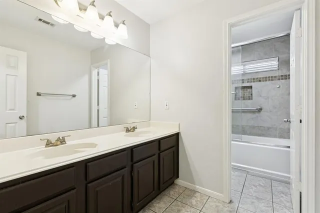 a bathroom with a double vanity sink and a mirror