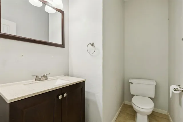 a bathroom with a sink vanity and a toilet