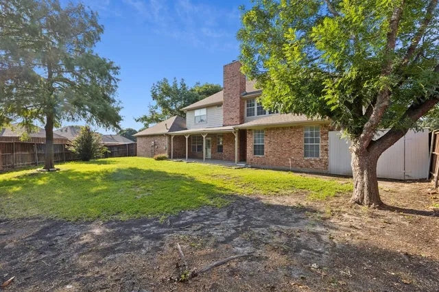 a front view of house with a garden