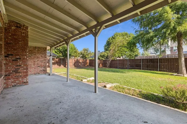 a view of a backyard with grass
