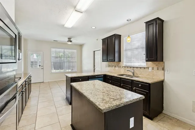 a kitchen with a stove a sink and a refrigerator