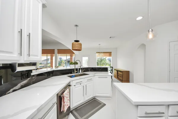 a kitchen with a sink a stove and cabinets