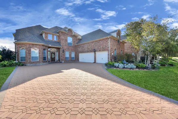 a front view of a house with a yard and trees