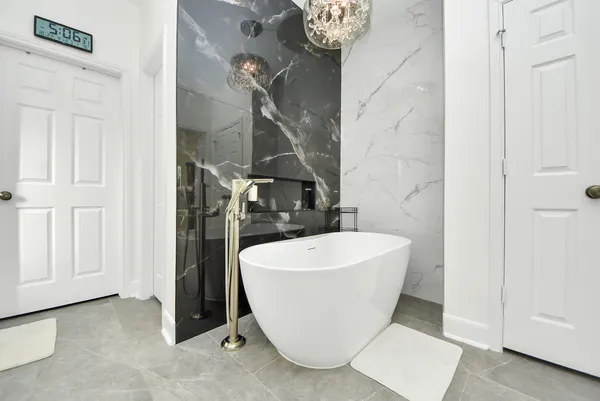 a bathroom with a bathtub and shower