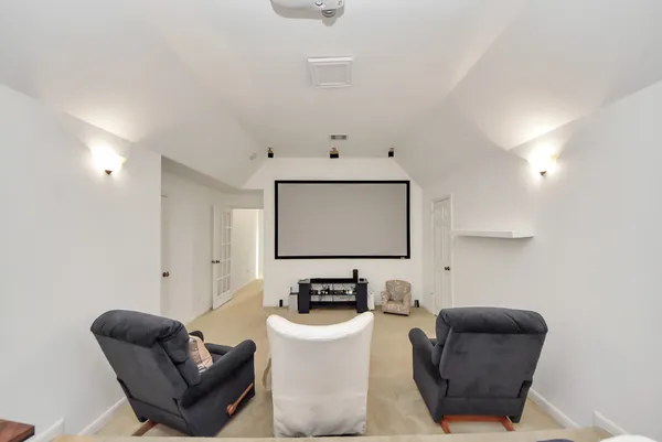a living room with furniture and a lamp