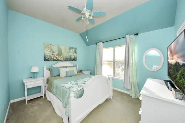 a bedroom with a bed mirror and a window