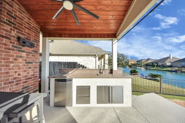 a view of a patio with a table and chairs under an umbrella