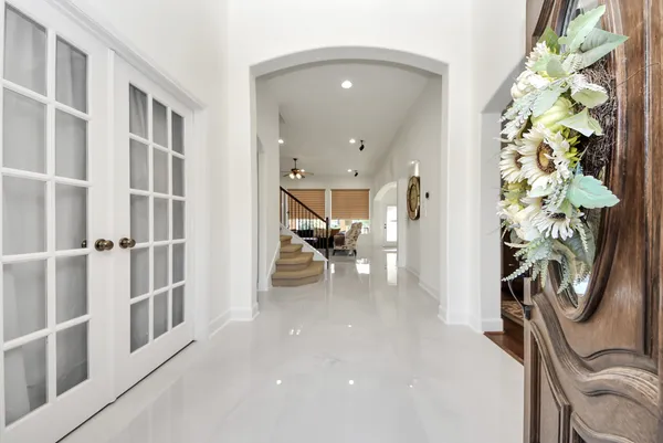 a view of a hallway with furniture and a potted plant