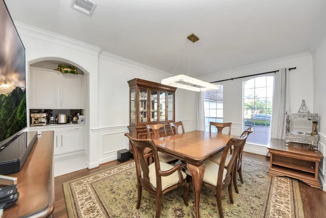 a kitchen with appliances cabinets and chairs