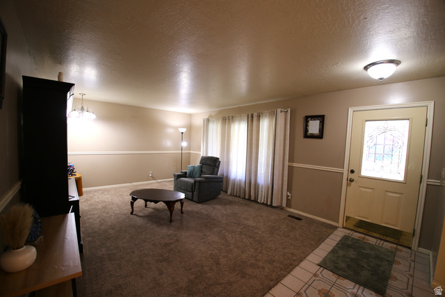 1612 East 450 South Springville, UT 84663 - Photo 12 of 48 Entryway with a decorative glass-paneled door, tile flooring, and overhead flush-mount lighting