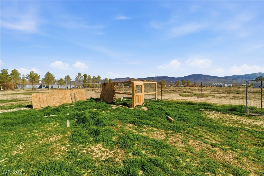 2780 West Simkins Road Pahrump, NV 89060 - Photo 35 of 40 A spacious, fenced property with open skies and distant mountain vistas, perfect for rural living.
