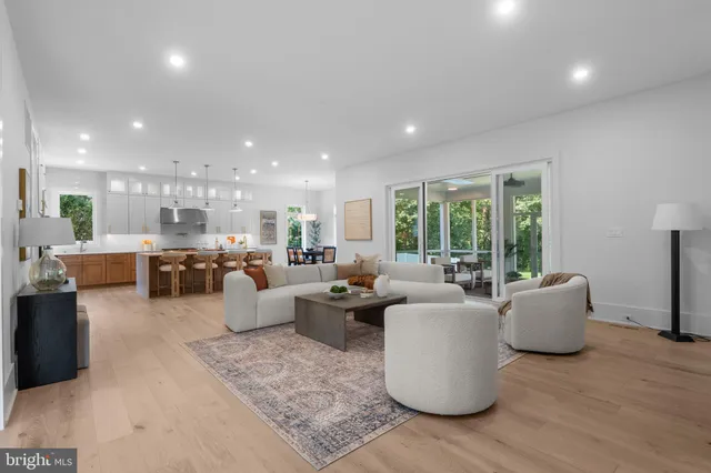 a large kitchen with a table chairs appliances and cabinets