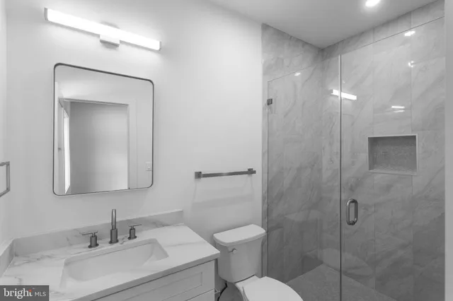 a spacious bathroom with a double vanity sink and a mirror