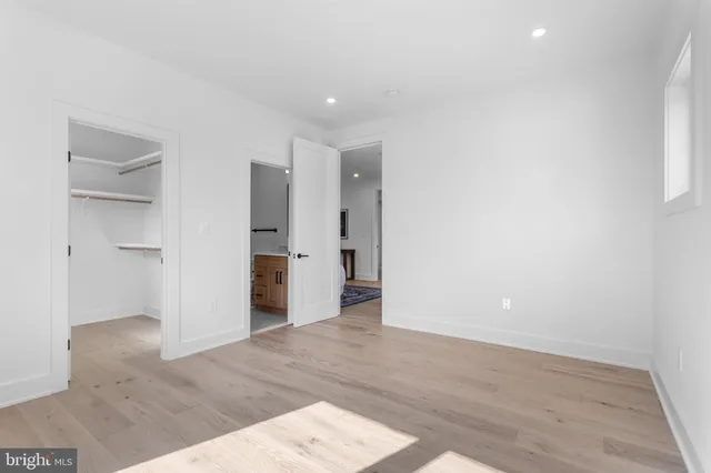 a spacious bathroom with a tub sink and mirror