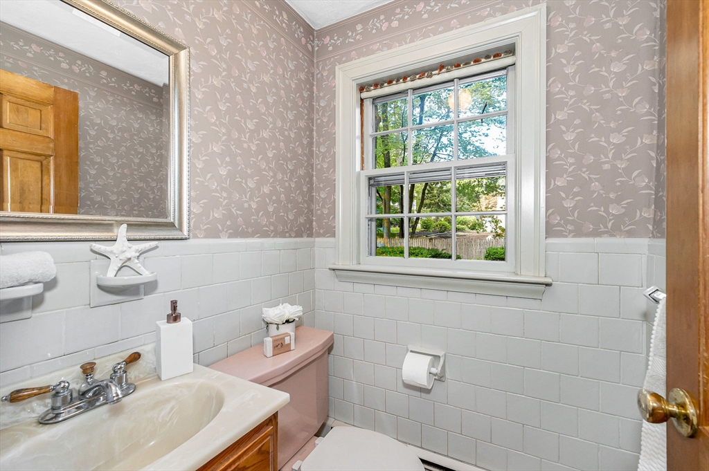 8 Greenwood Road Reading, MA 01867 - Photo 12 of 39 a bathroom with a sink a toilet and a mirror