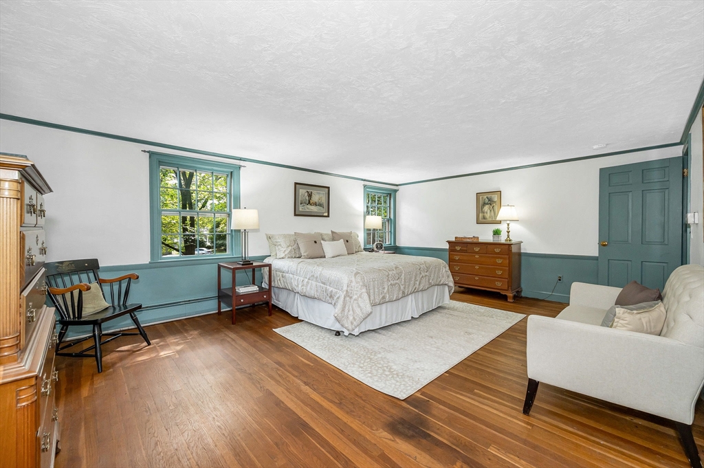 8 Greenwood Road Reading, MA 01867 - Photo 17 of 39 a bedroom with a bed and a couch