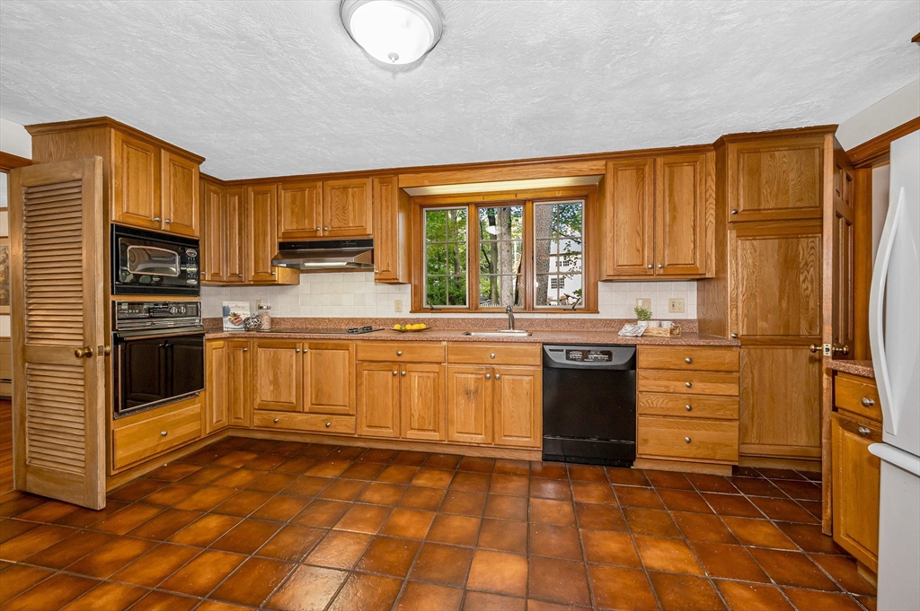 8 Greenwood Road Reading, MA 01867 - Photo 2 of 39 a kitchen with stainless steel appliances granite countertop a stove a sink and a refrigerator