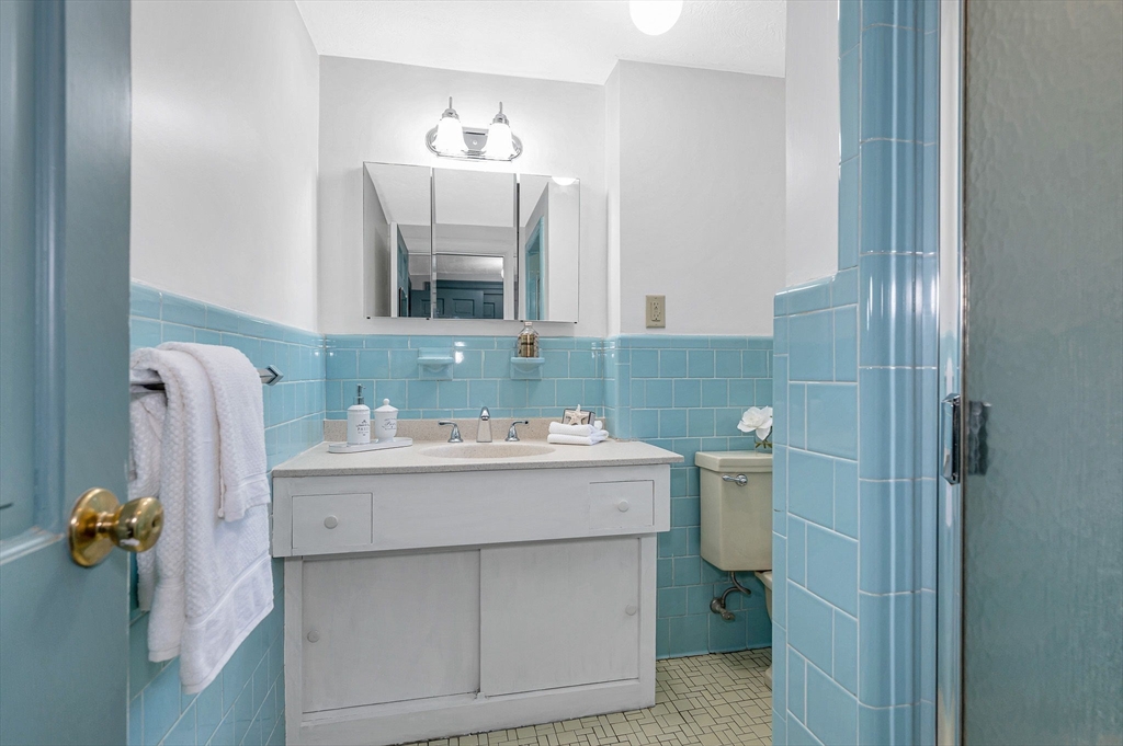 8 Greenwood Road Reading, MA 01867 - Photo 28 of 39 a bathroom with a sink and mirror