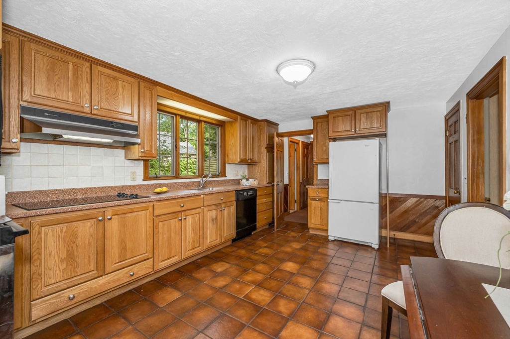 8 Greenwood Road Reading, MA 01867 - Photo 3 of 39 a kitchen with sink cabinets and refrigerator