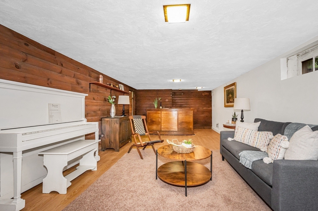8 Greenwood Road Reading, MA 01867 - Photo 31 of 39 a living room with furniture and a table