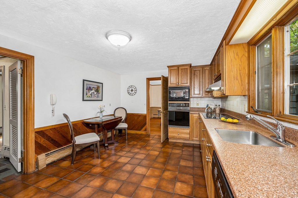 8 Greenwood Road Reading, MA 01867 - Photo 4 of 39 a kitchen with granite countertop a sink and a counter top space