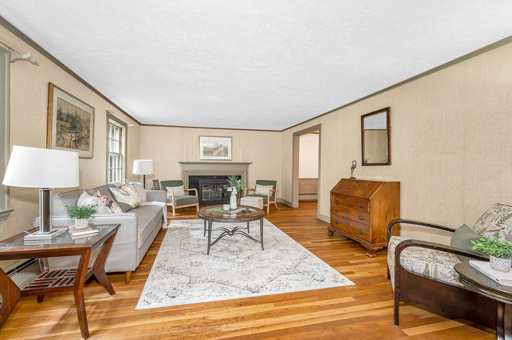 8 Greenwood Road Reading, MA 01867 - Photo 9 of 39 a living room with furniture and a fireplace