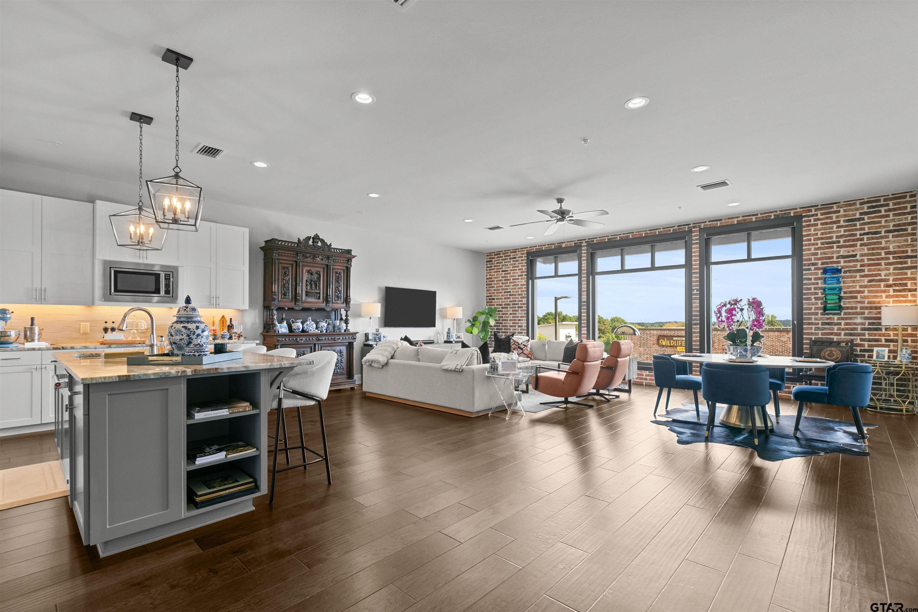 2981 Crest Ridge Drive, Unit 7 Tyler, TX 75703 - Photo 1 of 22 a living room with furniture kitchen view and a wooden floor