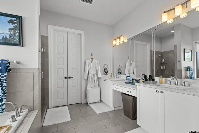 a bathroom with a double vanity sink and a mirror